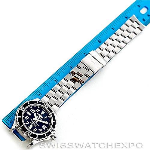 The image shows a Breitling Superocean A17364 Men's Stainless Steel Black Dial A17364 Men's Stainless Steel Black Dial watch with a metal bracelet, displayed alongside a blue ruler for measurement.