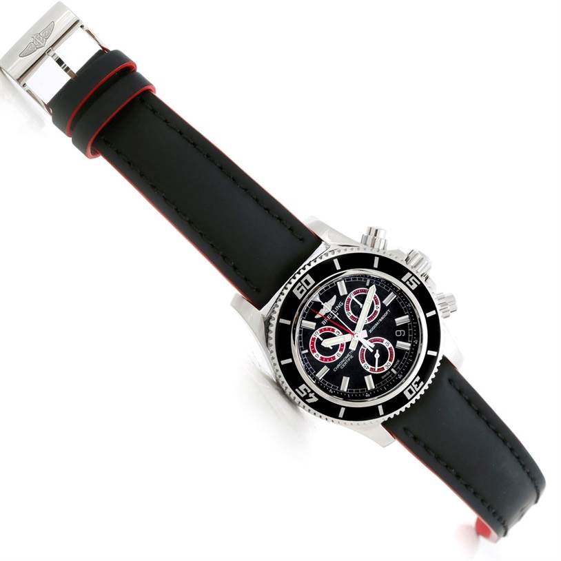 The image shows a Breitling Superocean A73310 Men's Stainless Steel Black Dial A73310 Men's Stainless Steel Black Dial watch at a top-down angle, highlighting the watch's face, bezel, and black strap with red edges.