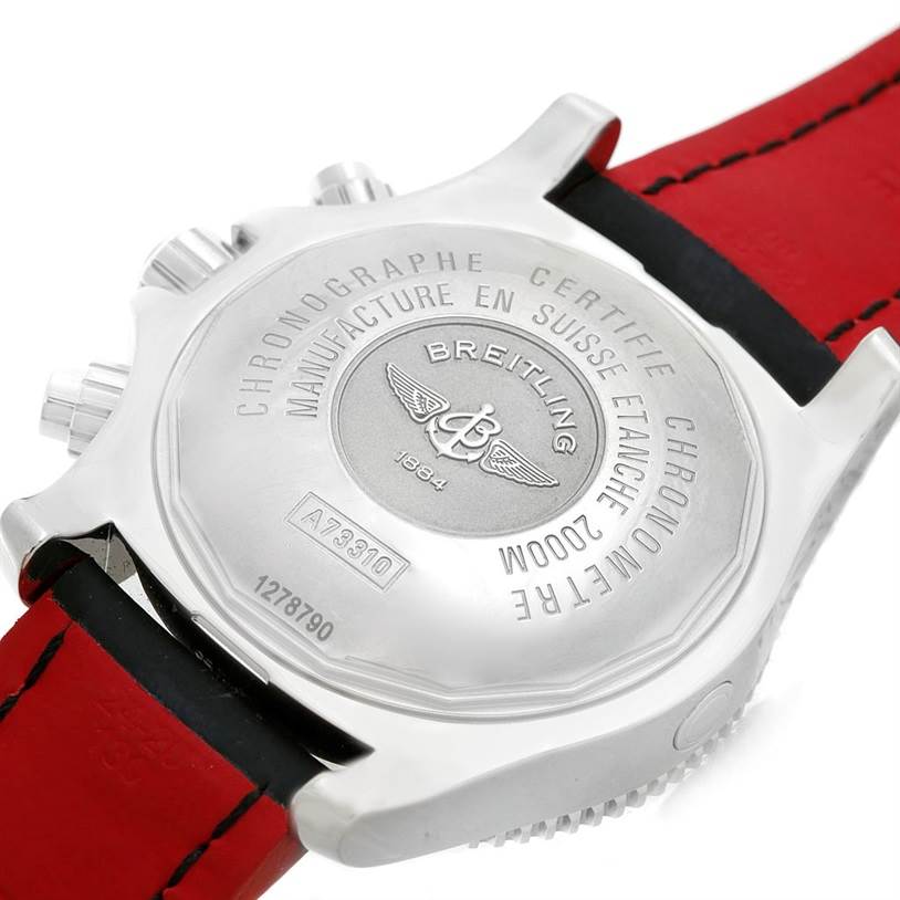 The image shows the case back of a Breitling Superocean A73310 Men's Stainless Steel Black Dial A73310 Men's Stainless Steel Black Dial watch, highlighting the engraved details and red strap.