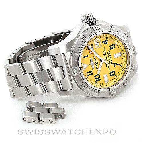 The image shows a side and partial front view of a Breitling Avenger A17330 Men's Stainless Steel Yellow Dial A17330 Men's Stainless Steel Yellow Dial watch with yellow dial and extra bracelet links.