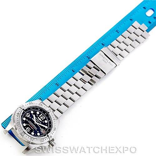 This image shows a Breitling Superocean A17390 Men's Stainless Steel Black Dial A17390 Men's Stainless Steel Black Dial watch at an angled top view, displaying the face, bezel, and metal bracelet alongside a ruler for scale.