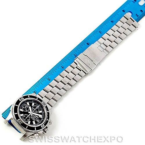 The Breitling Superocean A13341 Men
s Stainless Steel Black Dial A13341 Men
s Stainless Steel Black Dial watch is shown from a top-down angle, displaying the face, bezel, bracelet, and clasp alongside a ruler.