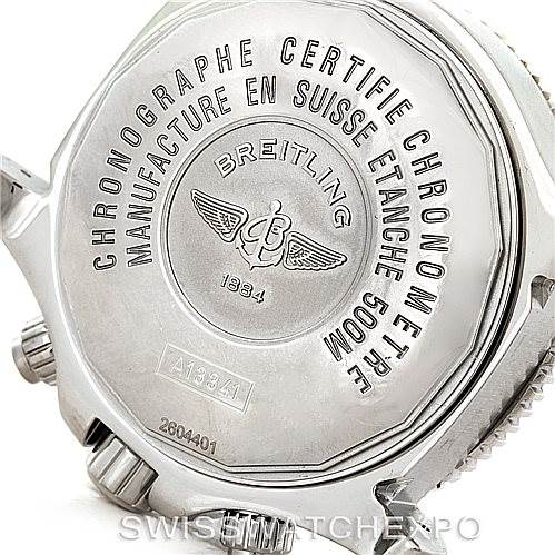 The image shows the back case of a Breitling Superocean A13341 Men
s Stainless Steel Black Dial A13341 Men
s Stainless Steel Black Dial watch, highlighting its engravings and crown.