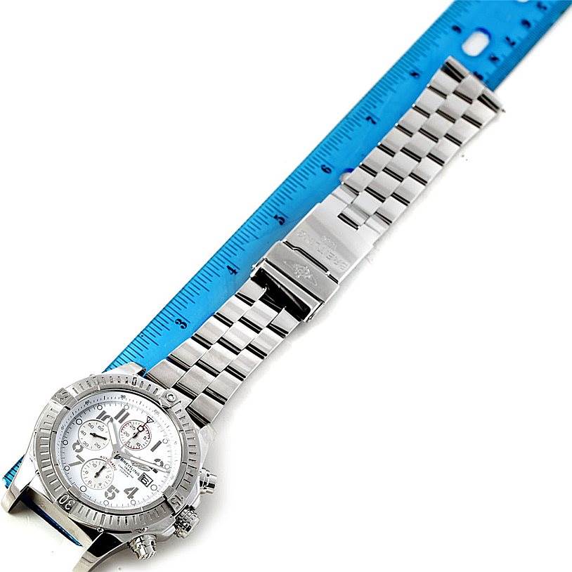 This image shows a Breitling Avenger A13370 Men's Stainless Steel White Dial A13370 Men's Stainless Steel White Dial watch laid flat with a ruler measuring its metal bracelet length.