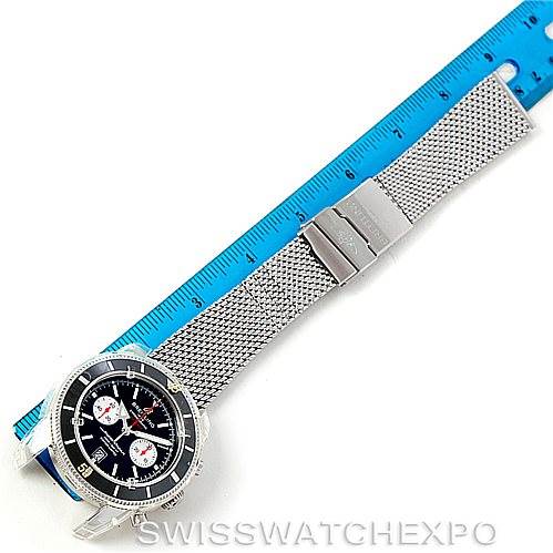 The image shows a Breitling Superocean A23320 Men's Stainless Steel Black Dial A23320 Men's Stainless Steel Black Dial watch with a mesh metal strap, displayed next to a ruler for scale.