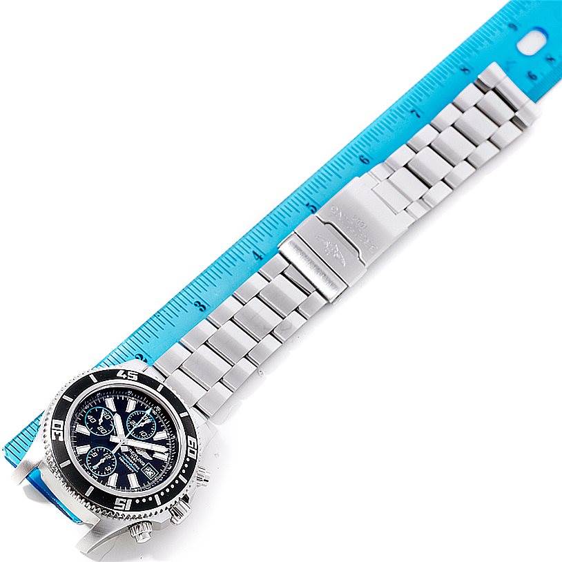 The image shows a Breitling Superocean A13341 Men's Stainless Steel Black Dial A13341 Men's Stainless Steel Black Dial watch with a stainless steel bracelet laid next to a ruler for measurement.