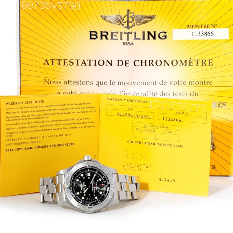 The image shows a Breitling Superocean A17390 Men's Stainless Steel Black Dial A17390 Men's Stainless Steel Black Dial watch and its warranty certificates, photographed from the front.