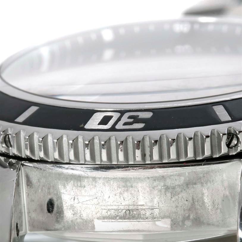 The image shows a close-up, side angle of the bezel and part of the case of a Breitling Superocean A17364 Men's Stainless Steel Black Dial A17364 Men's Stainless Steel Black Dial watch.
