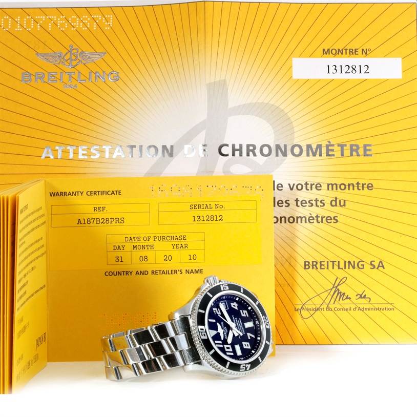 The image shows a Breitling Superocean A17364 Men's Stainless Steel Black Dial A17364 Men's Stainless Steel Black Dial watch and its warranty certificate, serial number, and chronometer attestation.