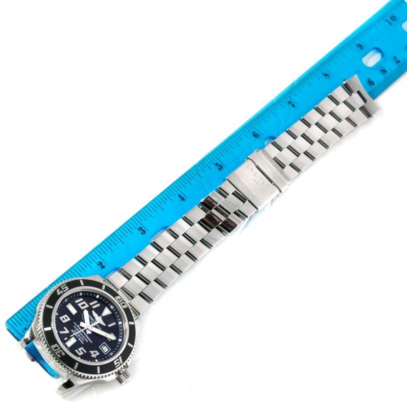 The Breitling Superocean A17364 Men's Stainless Steel Black Dial A17364 Men's Stainless Steel Black Dial watch is shown from a top-down angle alongside a blue ruler.
