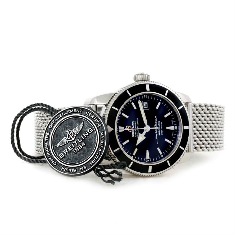 The Breitling Superocean A17320 Men's Stainless Steel Black Dial A17320 Men's Stainless Steel Black Dial watch is displayed at a slight angle, showing the face, bezel, crown, and metal mesh band, along with a Breitling tag.