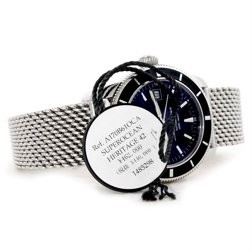 The image shows the Breitling Superocean A17320 Men's Stainless Steel Black Dial A17320 Men's Stainless Steel Black Dial Heritage 42 watch angled from the side, focusing on the mesh strap and part of the dial.