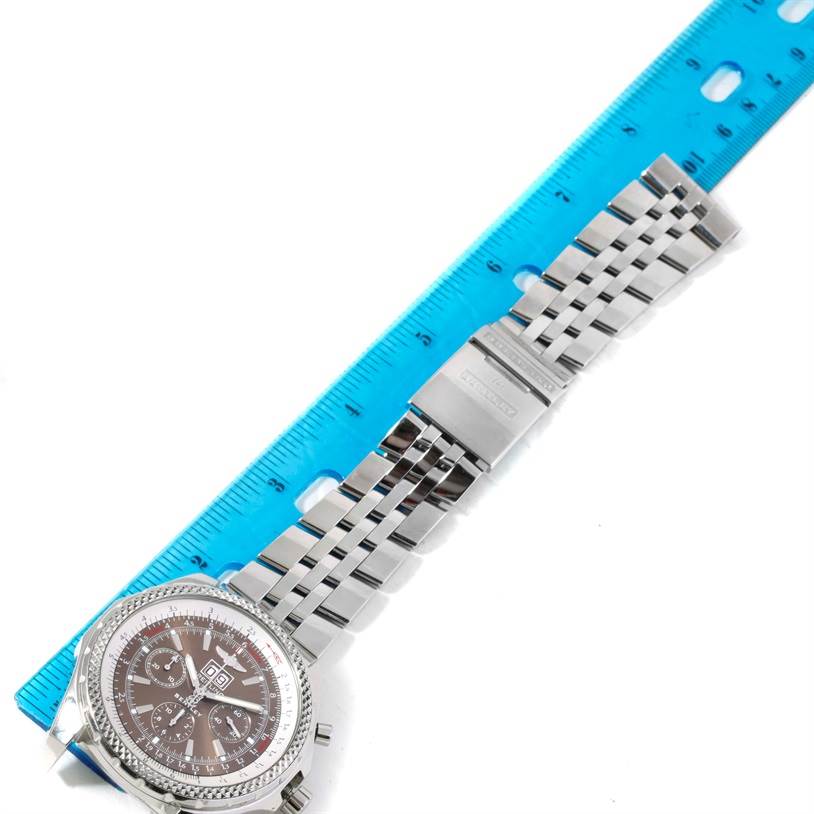 The image shows a top-down view of a Breitling Bentley A44362 Men's Stainless Steel Brown Dial A44362 Men's Stainless Steel Brown Dial watch, displaying the dial, metal strap, and clasp alongside a blue ruler.