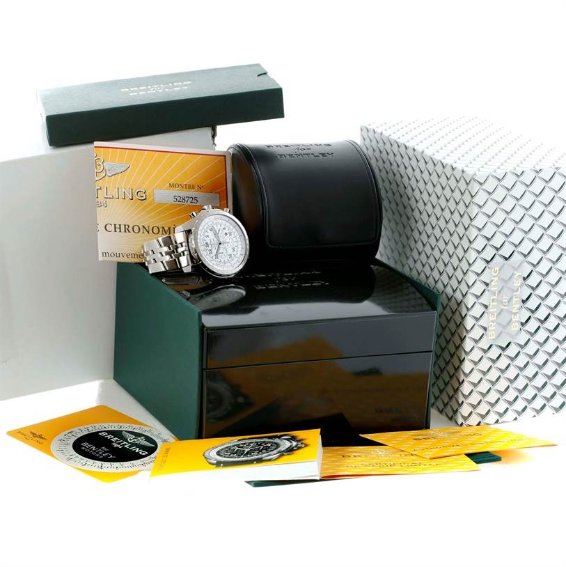 The image shows a Bentley model by Breitling watch with its box, case, and accompanying documentation, displayed from a high-angle viewpoint.