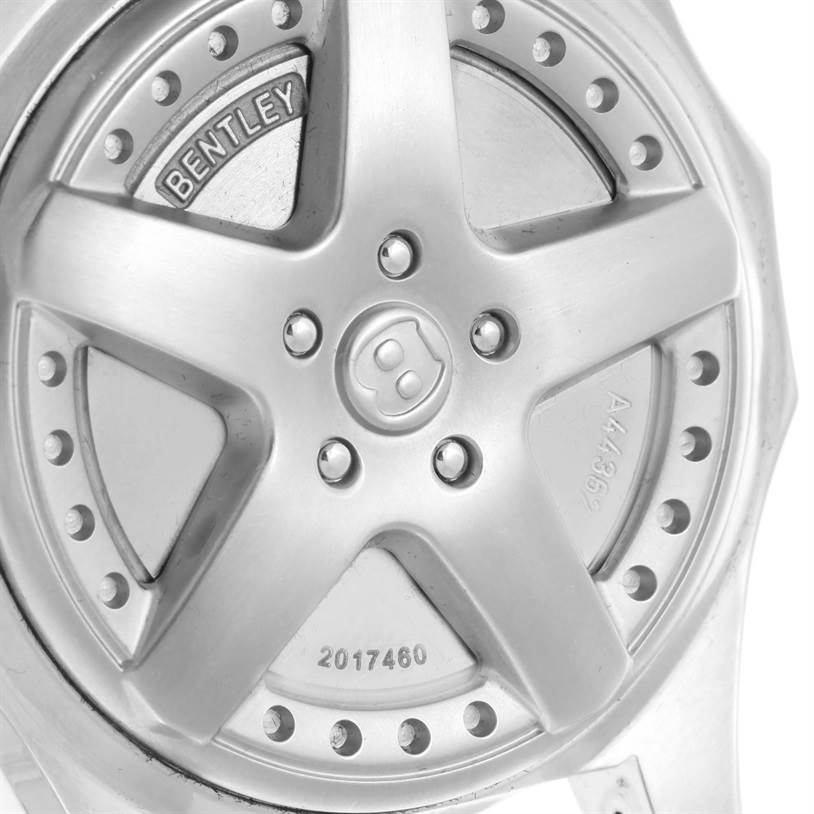 The image shows the case back of the Bentley model watch by Breitling, featuring a wheel rim design.