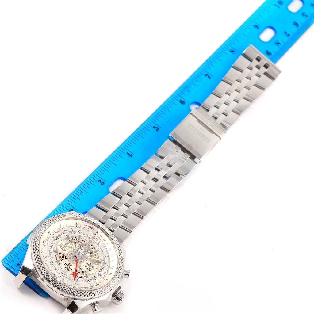 The image shows a Breitling Bentley AB0431 Men's Stainless Steel Silver Dial AB0431 Men's Stainless Steel Silver Dial watch laid flat, next to a ruler for scale, highlighting its band and face.