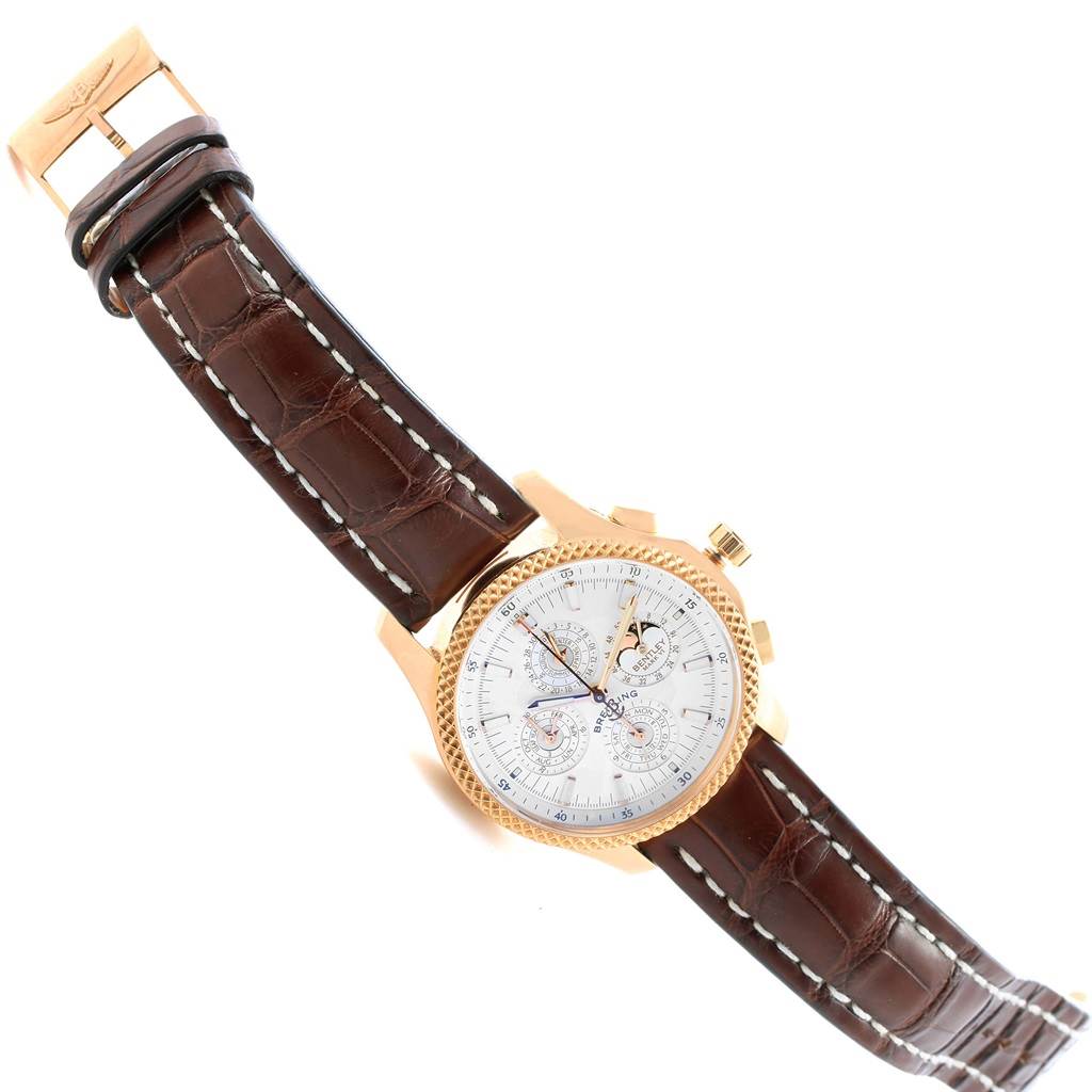 This Breitling Bentley H29363 Men's Rose Gold Silver Dial H29363 Men's Rose Gold Silver Dial watch is shown at an angled view revealing the face, bezel, crown, and leather strap.