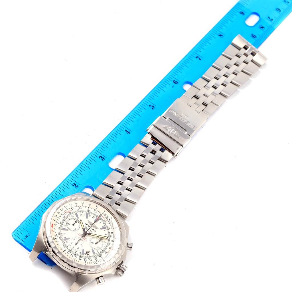 The image shows a top view of a Breitling Bentley A25363 Men's Stainless Steel White Dial A25363 Men's Stainless Steel White Dial watch displaying its face, bezel, and stainless steel bracelet next to a blue ruler.