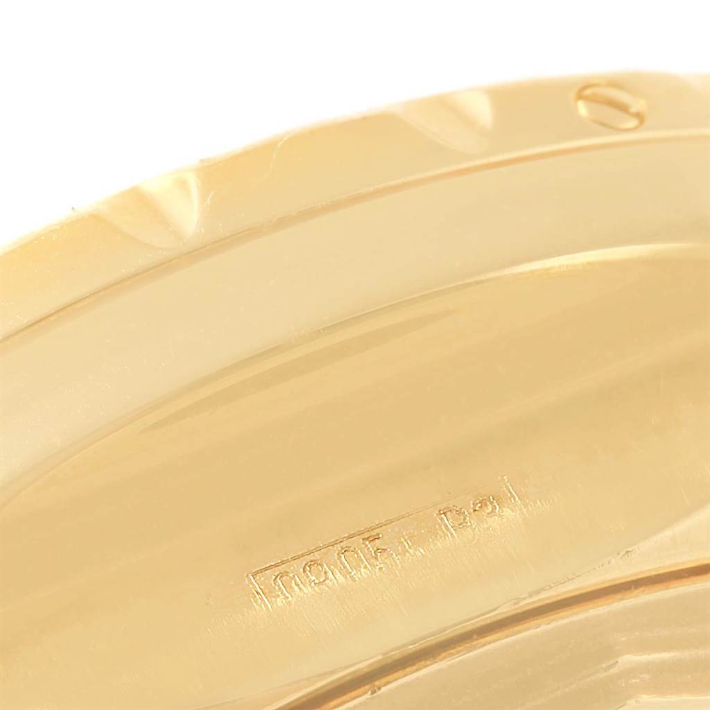 This image shows a close-up of the gold bezel of a Bentley model by Breitling.