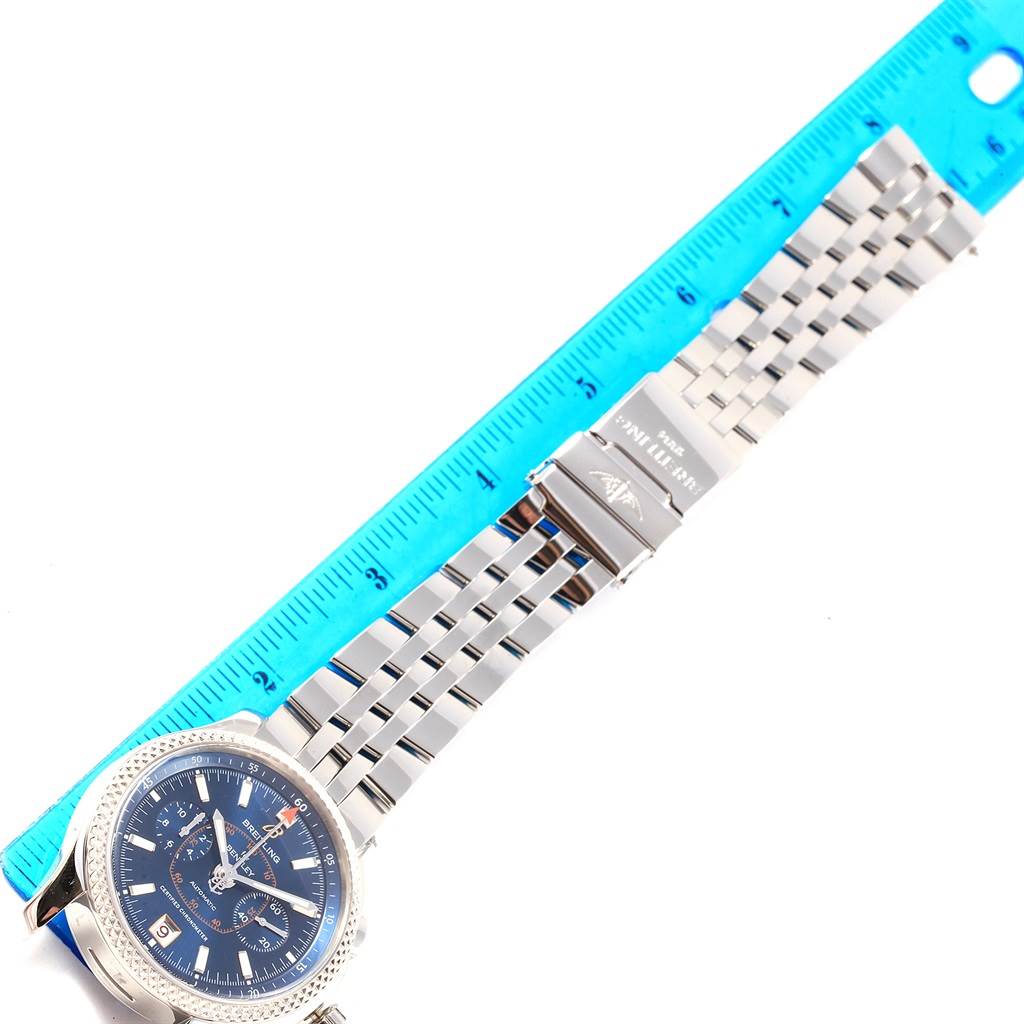 The image shows a Breitling Bentley P26362 Men's Stainless Steel Blue Dial P26362 Men's Stainless Steel Blue Dial watch laid flat with its face, bezel, and metal bracelet visible, alongside a blue ruler for scale.