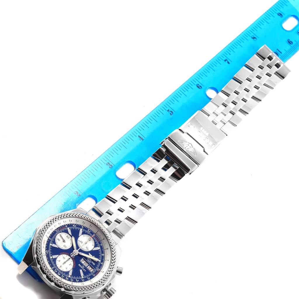 The image shows a Bentley model by Breitling from a top-down angle, displaying the watch face and metal bracelet alongside a ruler.