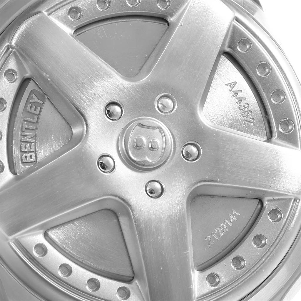 This image shows a close-up of a Bentley model wheel-inspired design by Breitling, highlighting the spokes and inscriptions.