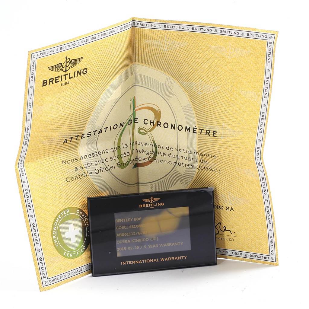 The image shows the Breitling Bentley AB061112-G802-754P Men's Stainless Steel Silver Dial AB061112-G802-754P Men's Stainless Steel Silver Dial model B06 watch's chronometer certificate and international warranty card from a front angle.