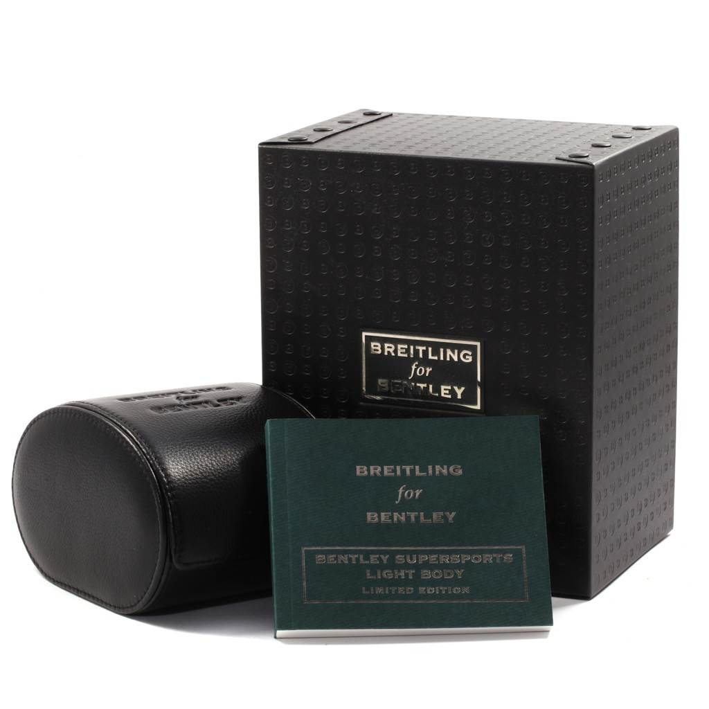 The image shows the packaging and manual for a Breitling Bentley E27365 Men's Titanium Black Dial E27365 Men's Titanium Black Dial model watch, including a black box and a cylindrical leather case.