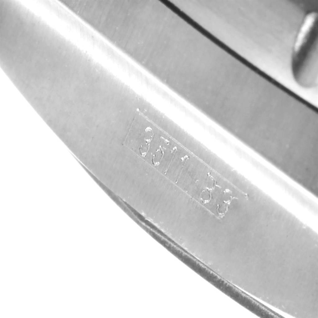 The image shows a close-up angle of the serial number engraved on the metal bracelet of a Breitling Bentley E27365 Men's Titanium Black Dial E27365 Men's Titanium Black Dial watch.
