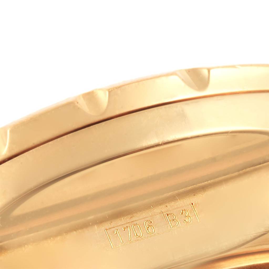 The image shows part of the gold bezel and engraved details of the Breitling Bentley K44362 Men's Yellow Gold Black Dial K44362 Men's Yellow Gold Black Dial watch model.