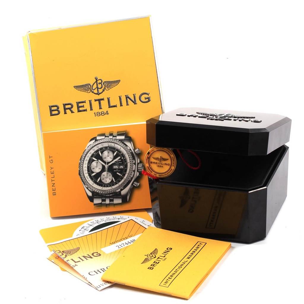 The image shows a Bentley model by Breitling with its box, booklet, warranty card, and tag from a front angle.