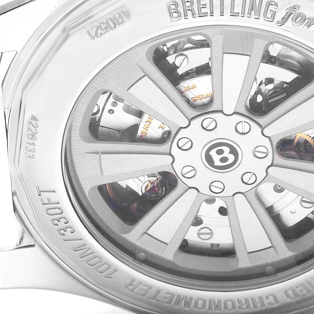 The image shows the detailed back and internal mechanism of a Bentley model by Breitling, highlighting the rotor design and engravings.