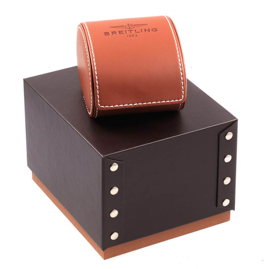 The Bentley model by Breitling is shown with its brown leather case and black box packaging, viewed from a slightly elevated angle.