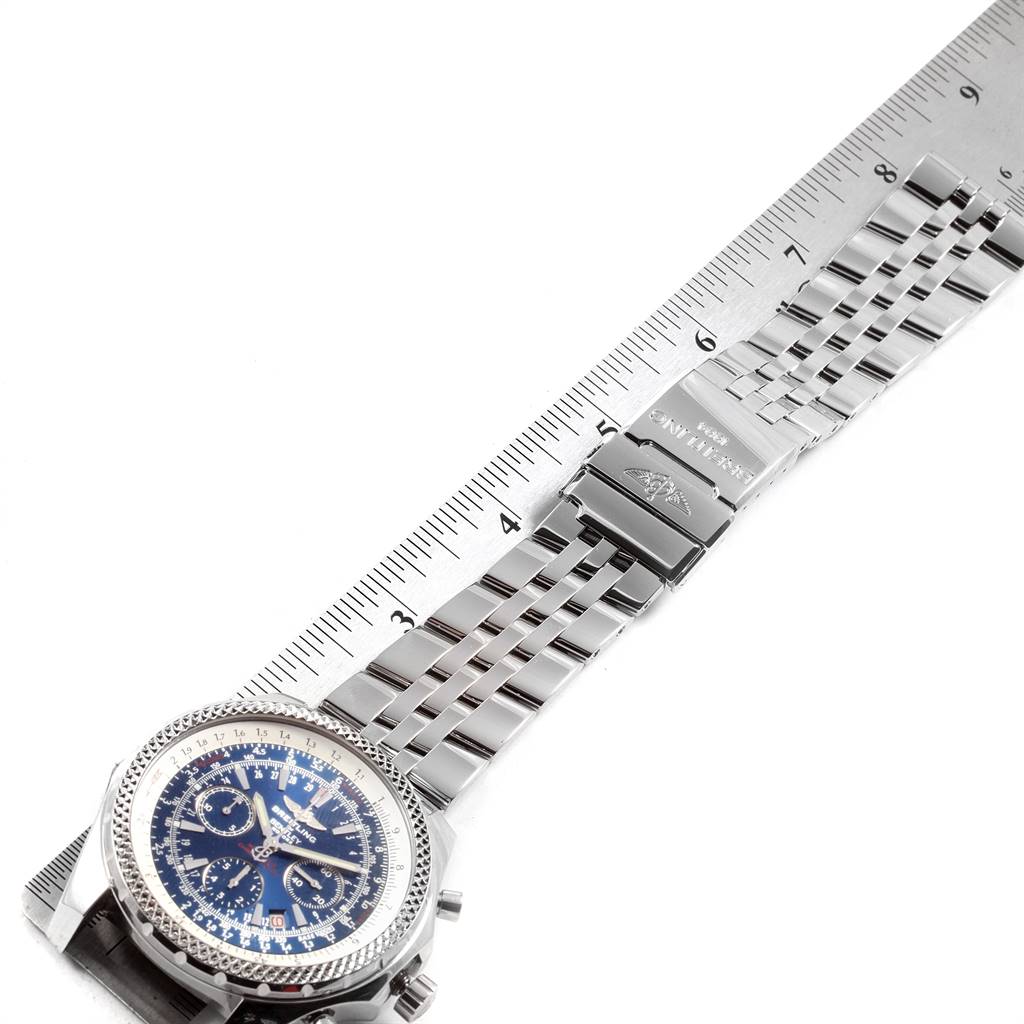 The image shows a Breitling Bentley A25362 Men's Stainless Steel Blue Dial A25362 Men's Stainless Steel Blue Dial watch flat, highlighting the face, metal strap, and clasp next to a ruler.