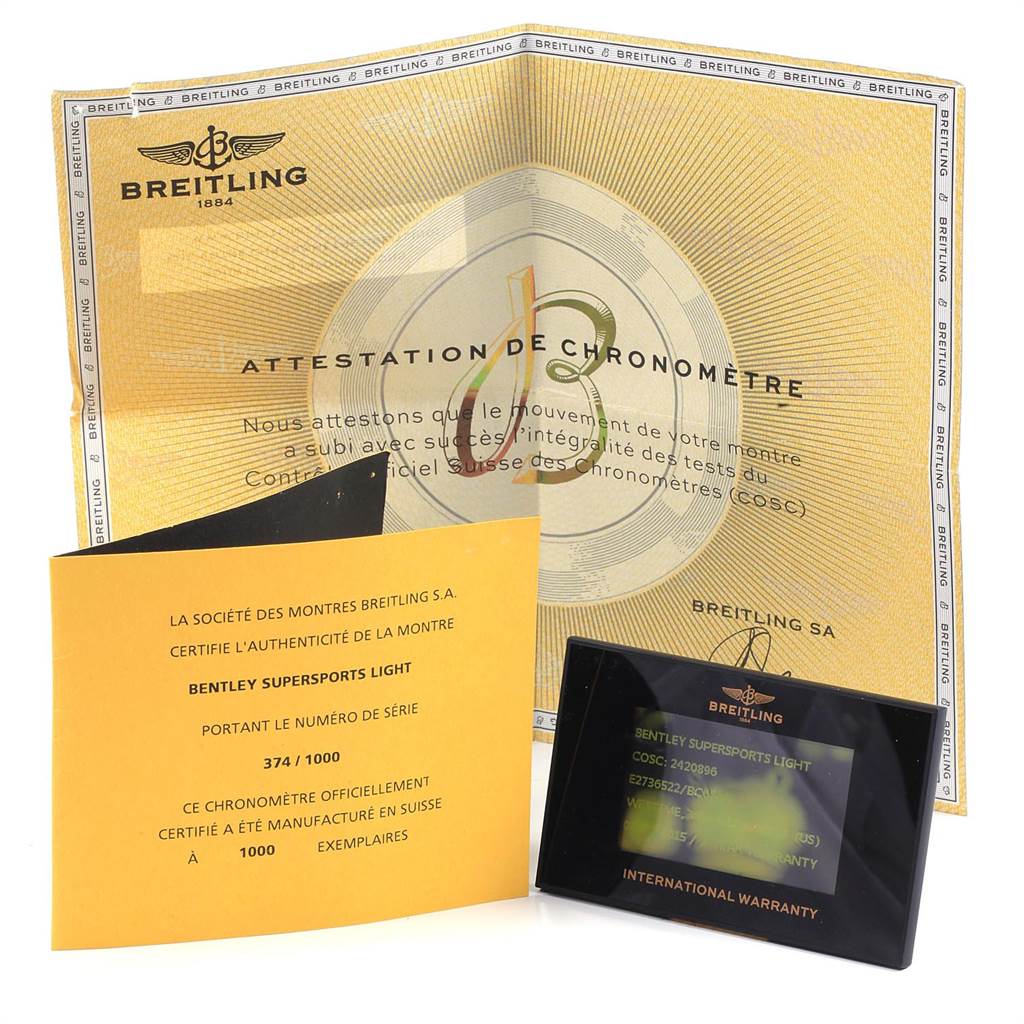 The image shows the warranty cards and certificate papers for the Breitling Bentley E27365 Men
s Titanium Black Dial E27365 Men
s Titanium Black Dial model at a frontal angle.