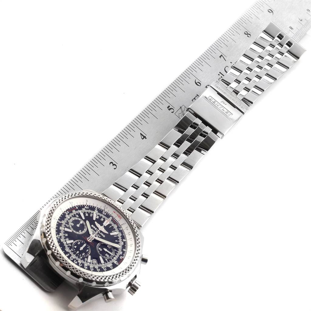 The image shows a Breitling Bentley A25362 Men
s Stainless Steel Black Dial A25362 Men
s Stainless Steel Black Dial watch from a top-down angle, displaying the face, bracelet, and clasp alongside a ruler for scale.