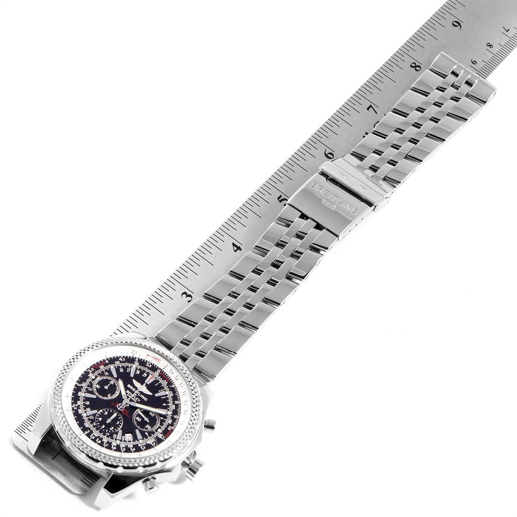 The Bentley model by Breitling is shown at an oblique angle, highlighting the watch face, bezel, and metal strap with a measurement ruler.