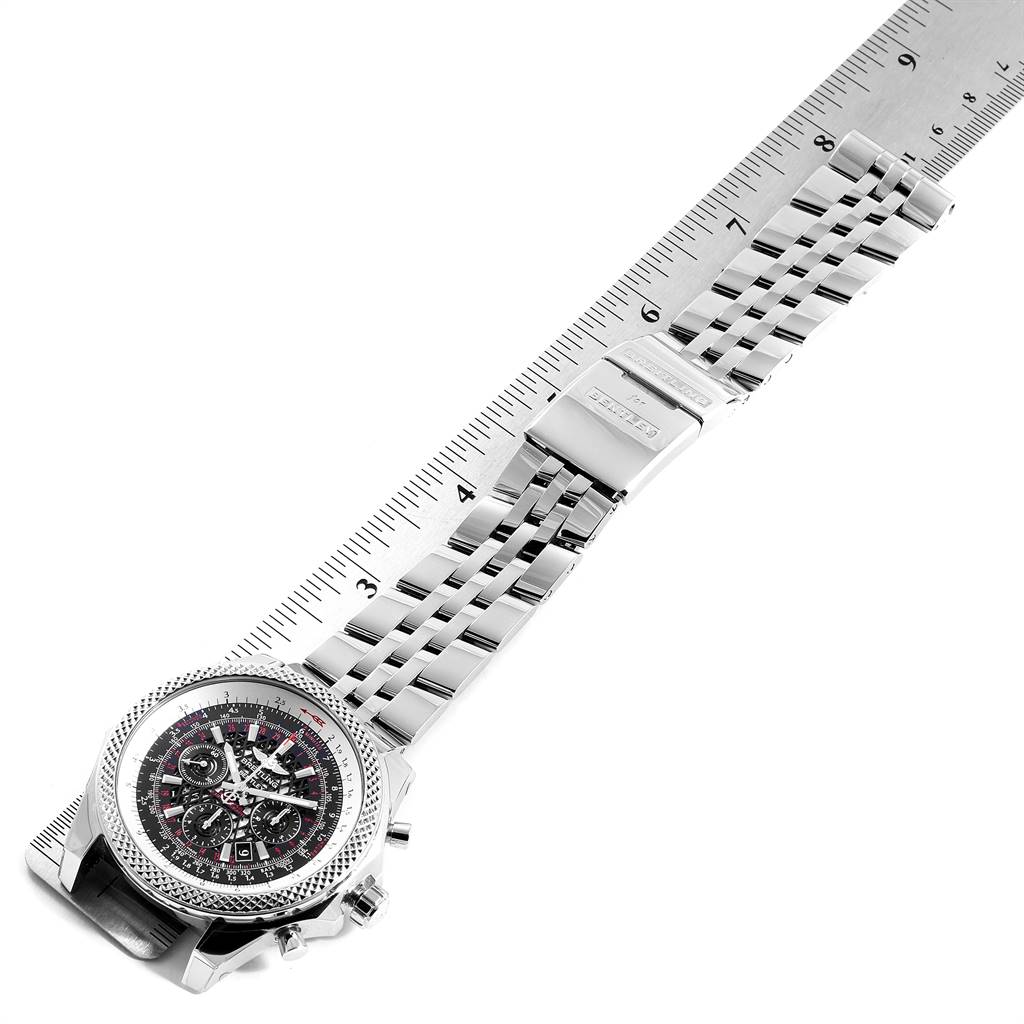 The image shows a Breitling Bentley AB061112.BD80.990A Men's Stainless Steel Black Dial AB061112.BD80.990A Men's Stainless Steel Black Dial watch laid flat, highlighting the face, bezel, and metal bracelet next to a ruler for scale.