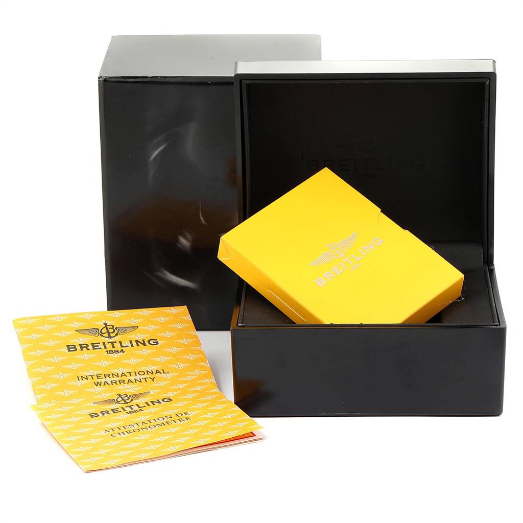 The image shows the packaging and warranty booklets for the Bentley model by Breitling, including a yellow booklet and a black box.