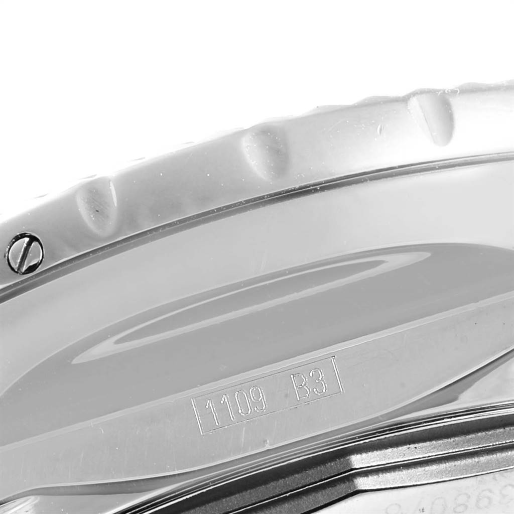 This close-up of the Breitling Bentley A25362 Men's Stainless Steel Silver Dial A25362 Men's Stainless Steel Silver Dial watch displays part of the bezel and case back, showing markings and screws.