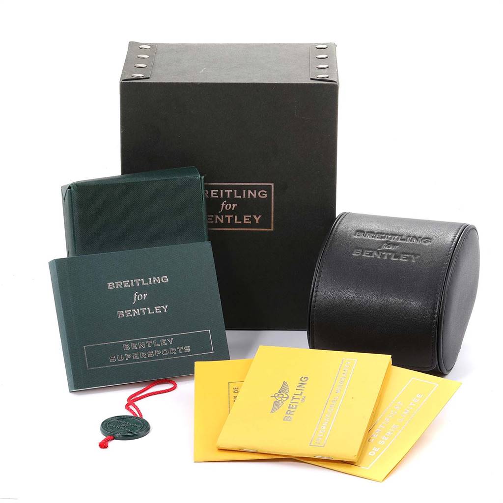 The image shows the packaging and accessories for the Bentley model by Breitling, including the box, manuals, and carrying case.