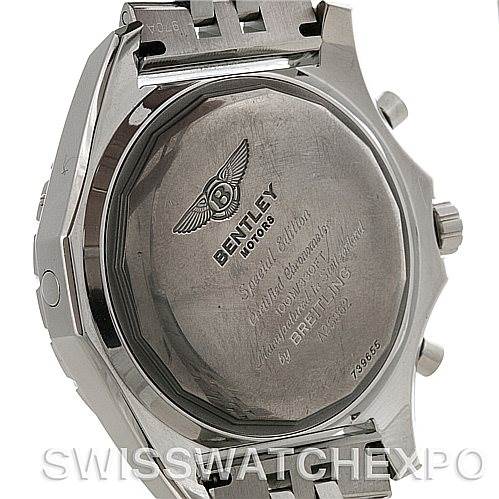 The image shows the back case of a Breitling watch, focusing on the engravings and clasp area.