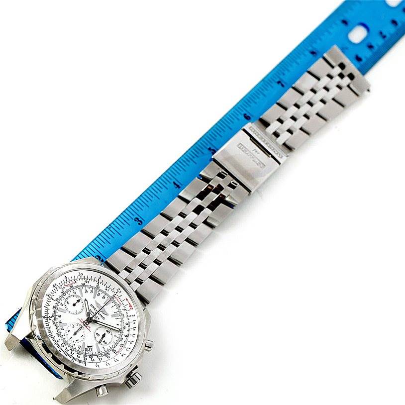 The Breitling Bentley A25363 Men's Stainless Steel Silver Dial A25363 Men's Stainless Steel Silver Dial watch is shown from a top-down angle, displaying its face and metal bracelet alongside a blue ruler.