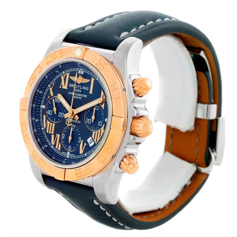 This Breitling Chronomat CB0110 Men's Steel and Gold (two tone) Blue Dial CB0110 Men's Steel and Gold (two tone) Blue Dial watch is shown at a three-quarter angle, displaying its face, bezel, crown, and part of the leather strap.
