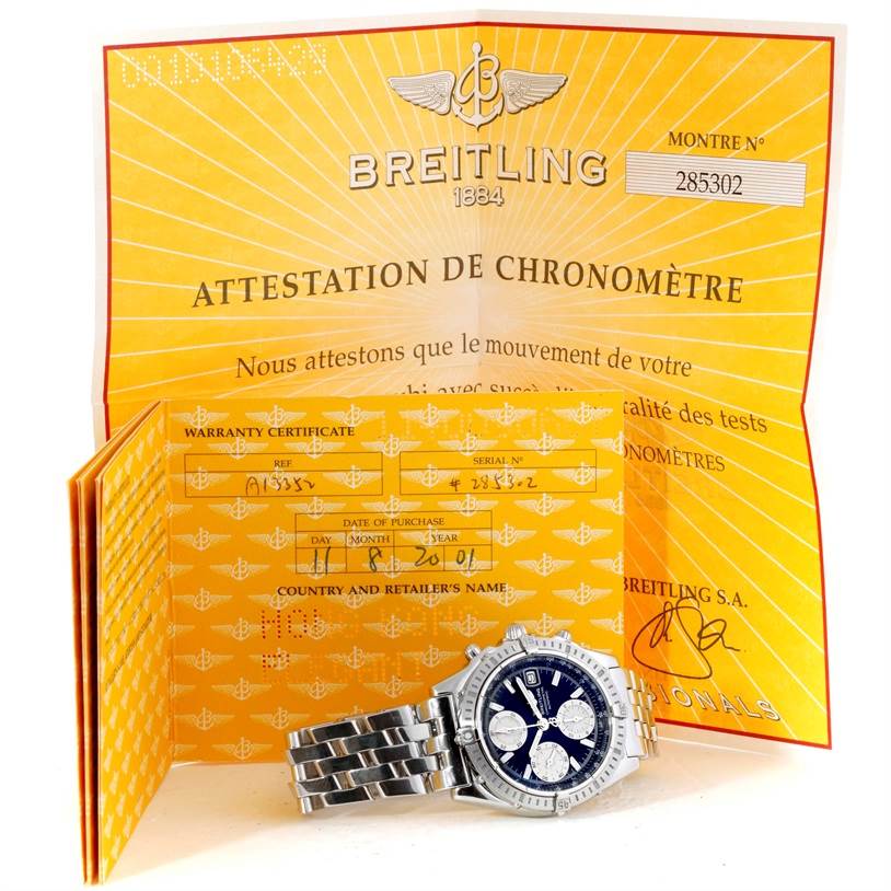 The image shows a front view of the Breitling Chronomat A13352 Men's Stainless Steel Black Dial A13352 Men's Stainless Steel Black Dial watch with its warranty certificate in the background.