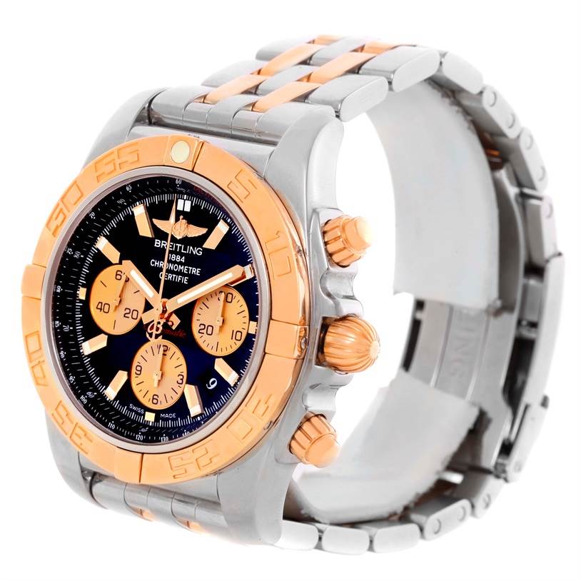 The image shows a Breitling Chronomat CB0110 Men's Steel and Gold (two tone) Black Dial CB0110 Men's Steel and Gold (two tone) Black Dial watch angled to display its face, bezel, crown, pushers, and a portion of the band.