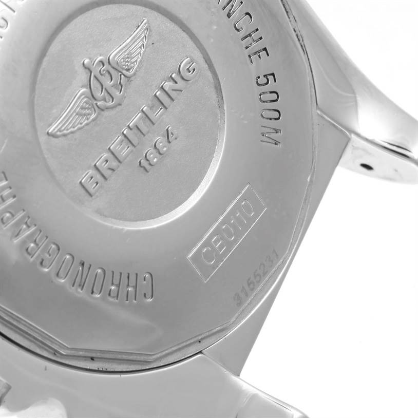 The image shows the back case of a Breitling Chronomat CB0110 Men's Steel and Gold (two tone) Black Dial CB0110 Men's Steel and Gold (two tone) Black Dial watch, highlighting the brand name and various engravings.