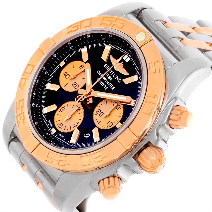 The Breitling Chronomat CB0110 Men's Steel and Gold (two tone) Black Dial CB0110 Men's Steel and Gold (two tone) Black Dial watch is shown from an angled side view, highlighting the dial, bezel, and crown.