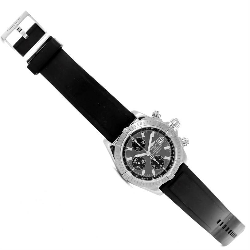 The image shows a Breitling Chronomat A13356 Men
s Stainless Steel Grey Dial A13356 Men
s Stainless Steel Grey Dial watch with a black dial, silver case, and a black rubber strap, viewed from a top-down angle.