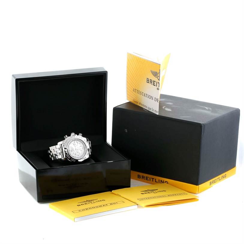The Breitling Chronomat AB0110 Men
s Stainless Steel White Dial AB0110 Men
s Stainless Steel White Dial watch is displayed at an angle showing its face and bracelet, accompanied by its box and documentation.